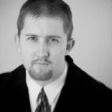 Portrait of Jeremy J. Benisek in a suit and tie.
